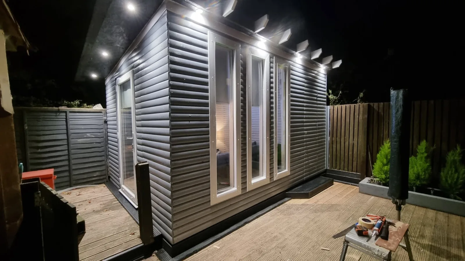 Grey garden room with decking and exterior lighting in South Lanarkshire